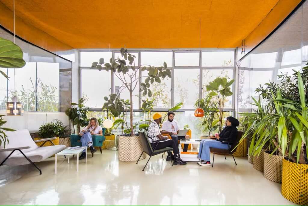 People chatting on rooftop terrace of co-working space Second Home in Spitalfields